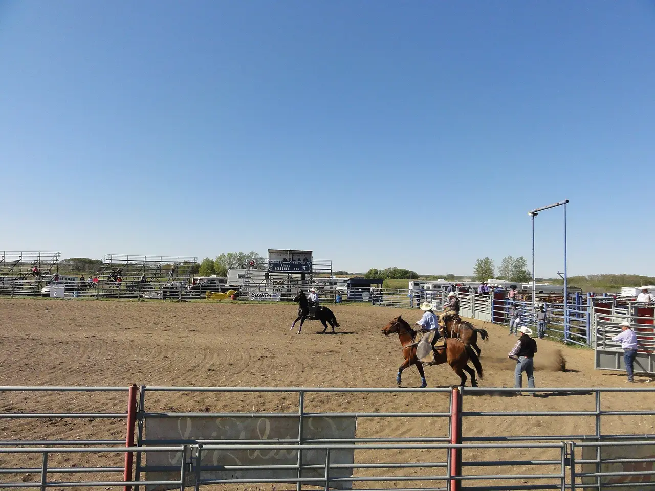 Rodeo arena with riders on horseback, 2013